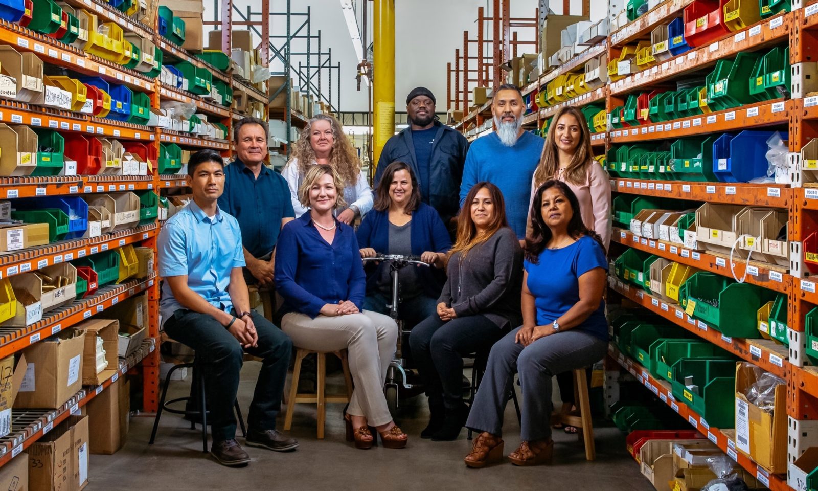 group of California Faucets employees surrounded by warehouse shelving