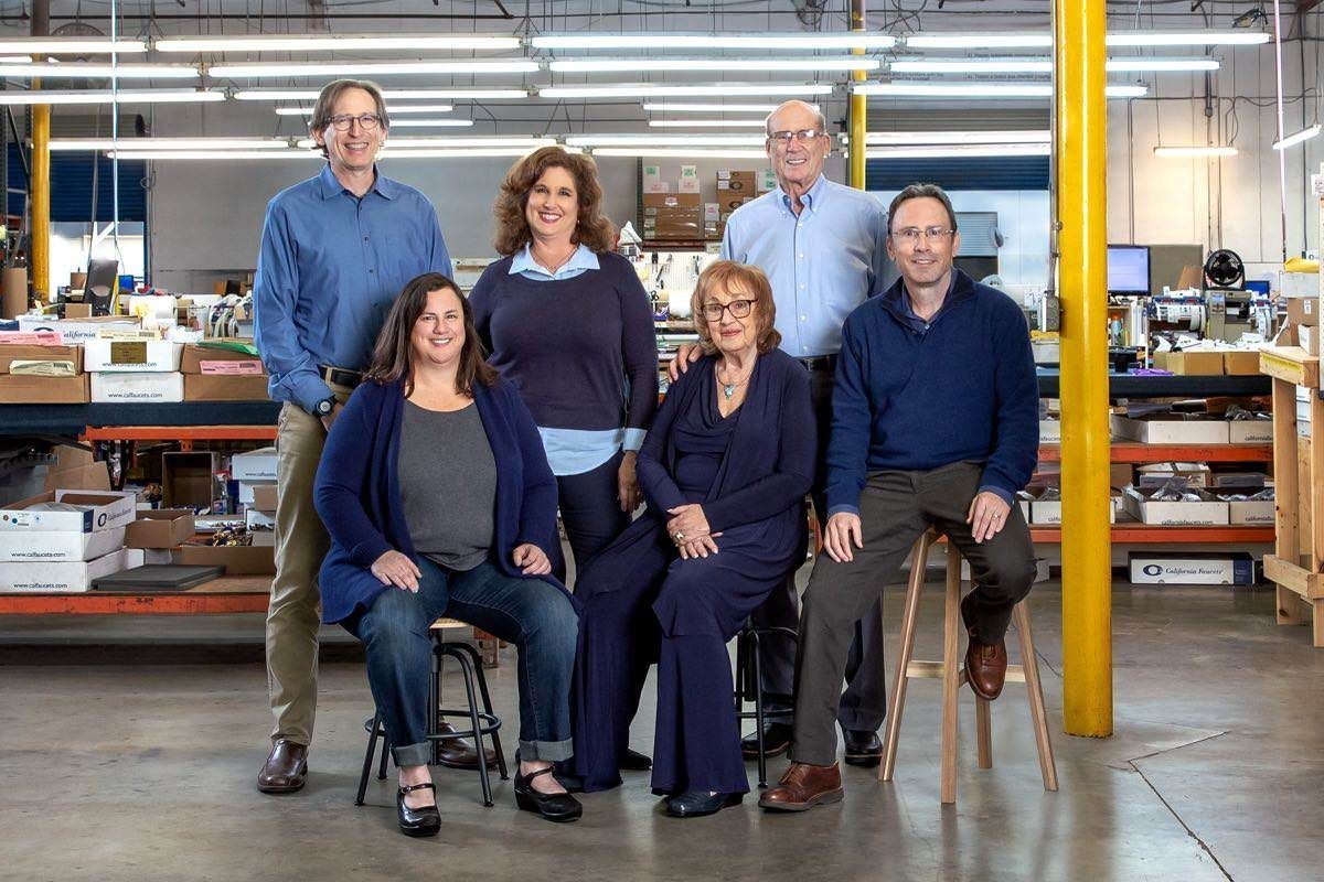 founding family sits for a portrait in factory